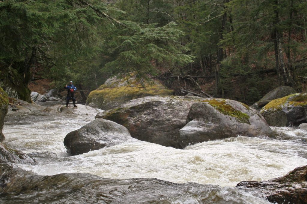 Simone Orlandi scouts a rapid on the Trout River Vermont Whitewater Kayaking